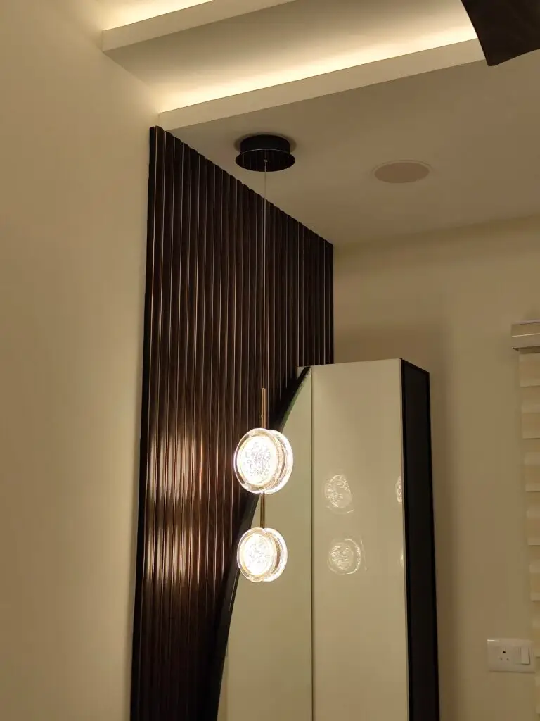 Modern bedroom interior with elegant wall lighting, wooden textures, and minimal design by Untold Concepts Chennai